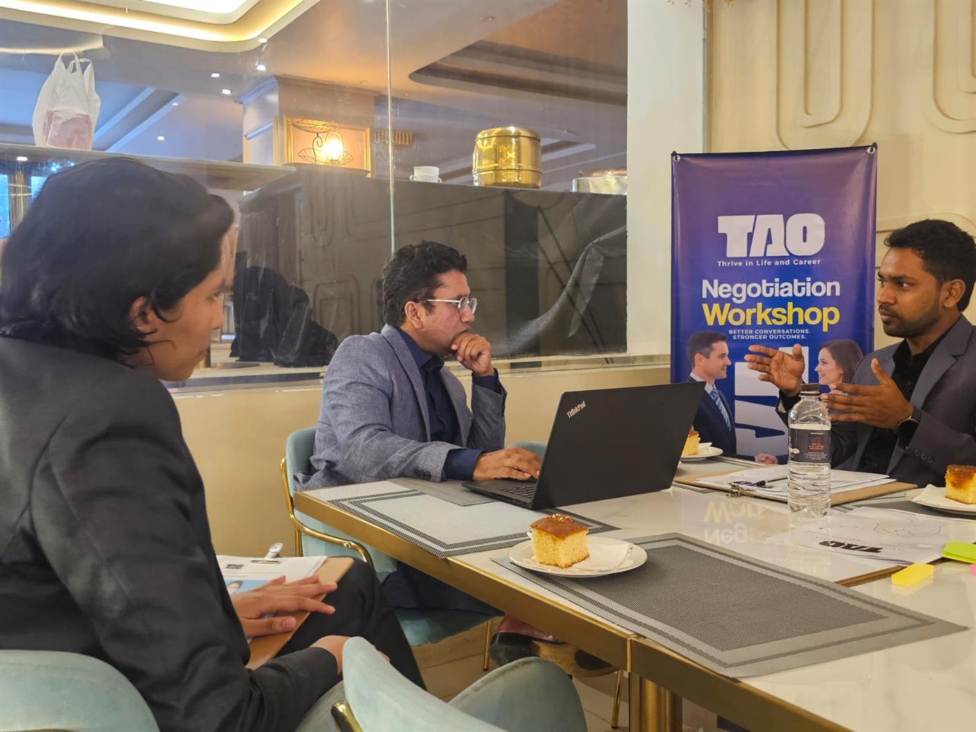 Participants working through a negotiation exercise around a table